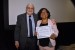 Dr. Nagib Callaos, General Chair, giving Dr. Maritza Placencia Medina the best paper award certificate of the session "Investigación, Educación y Solución de Problemas." The title of the awarded paper is "Programa MAAS: Diez años de Intervenciones Tecnológicas Educativas en la Facultad de Medicina en una Universidad Nacional de Perú."